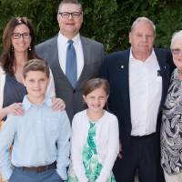 Award winner poses with family (outdoors)